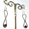 Silver infinity earrings with garnet angle