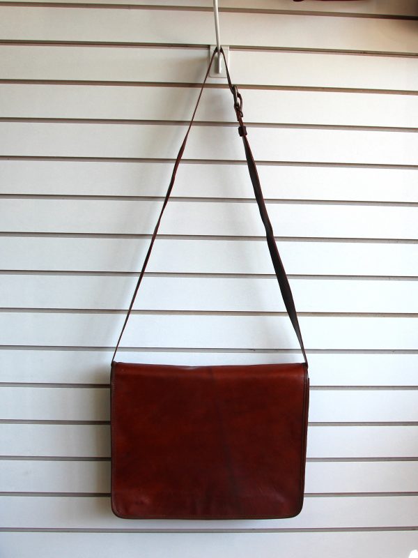 Leather briefcase hanging on slat wall
