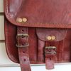 close up of leather bag with brass buckles