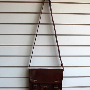 Leather purse with buckles hanging on slatwall